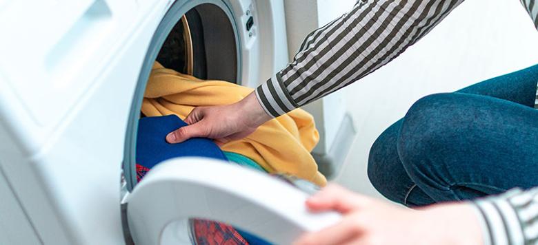 lady putting washing in a machine