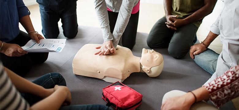 Group First aid training with CPR on dummy